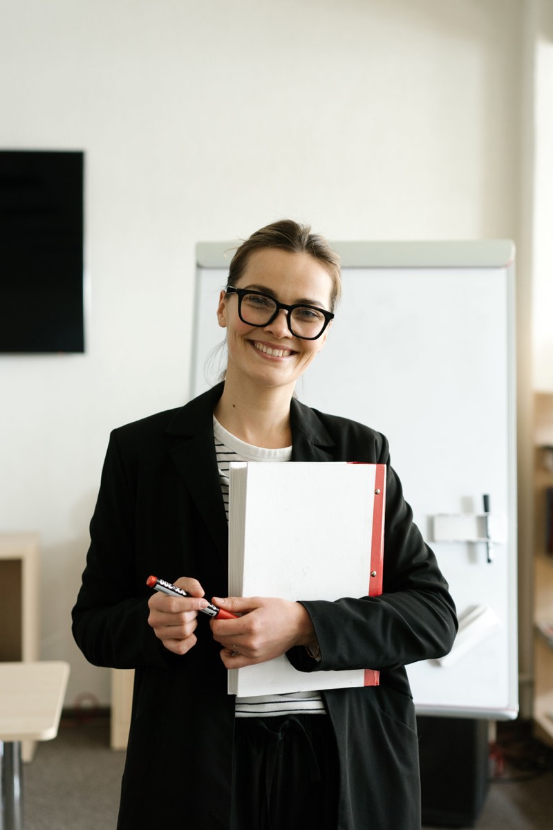 Illustrative stock photograph of an education professional smiling in a classroom